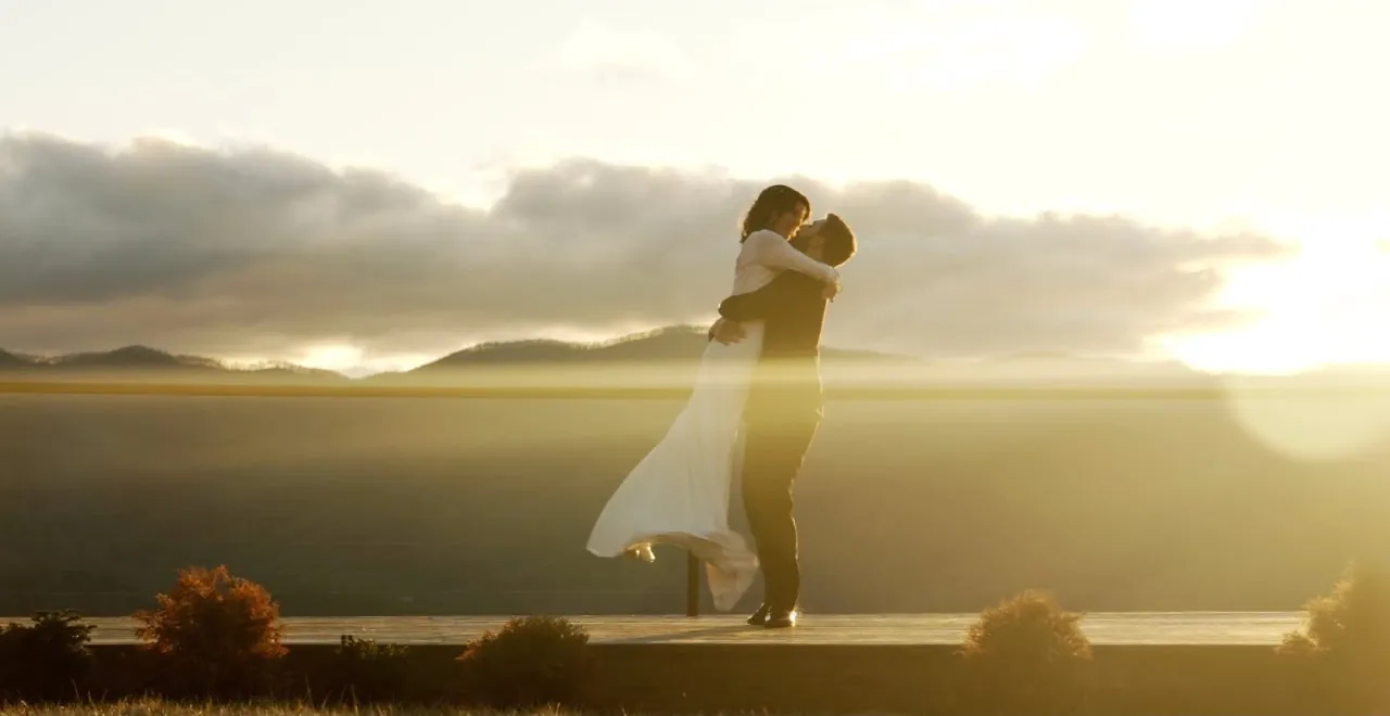 Bride and groom embracing at sunset over the Blue Ridge Mountains