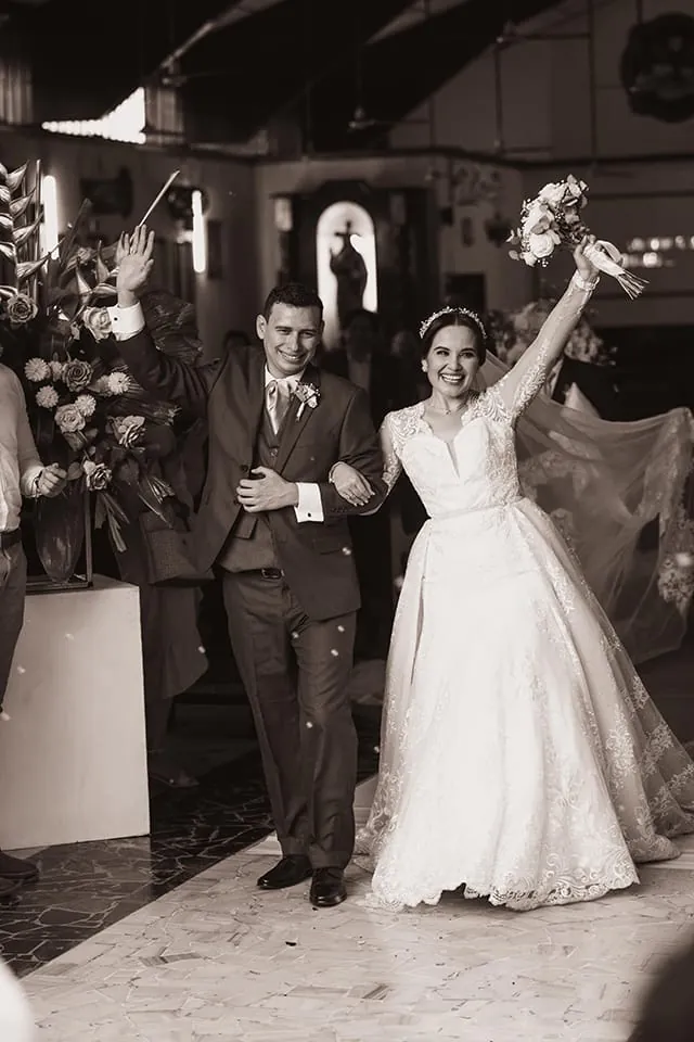 Black and white wedding exit with guests cheering